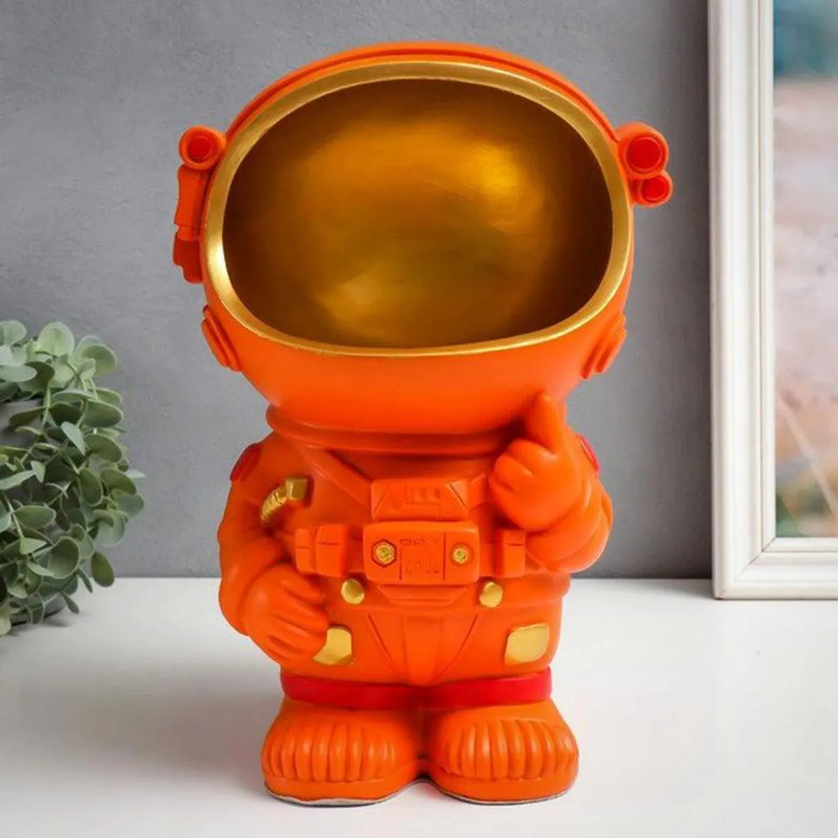 Front view of the orange astronaut tissue holder showpiece