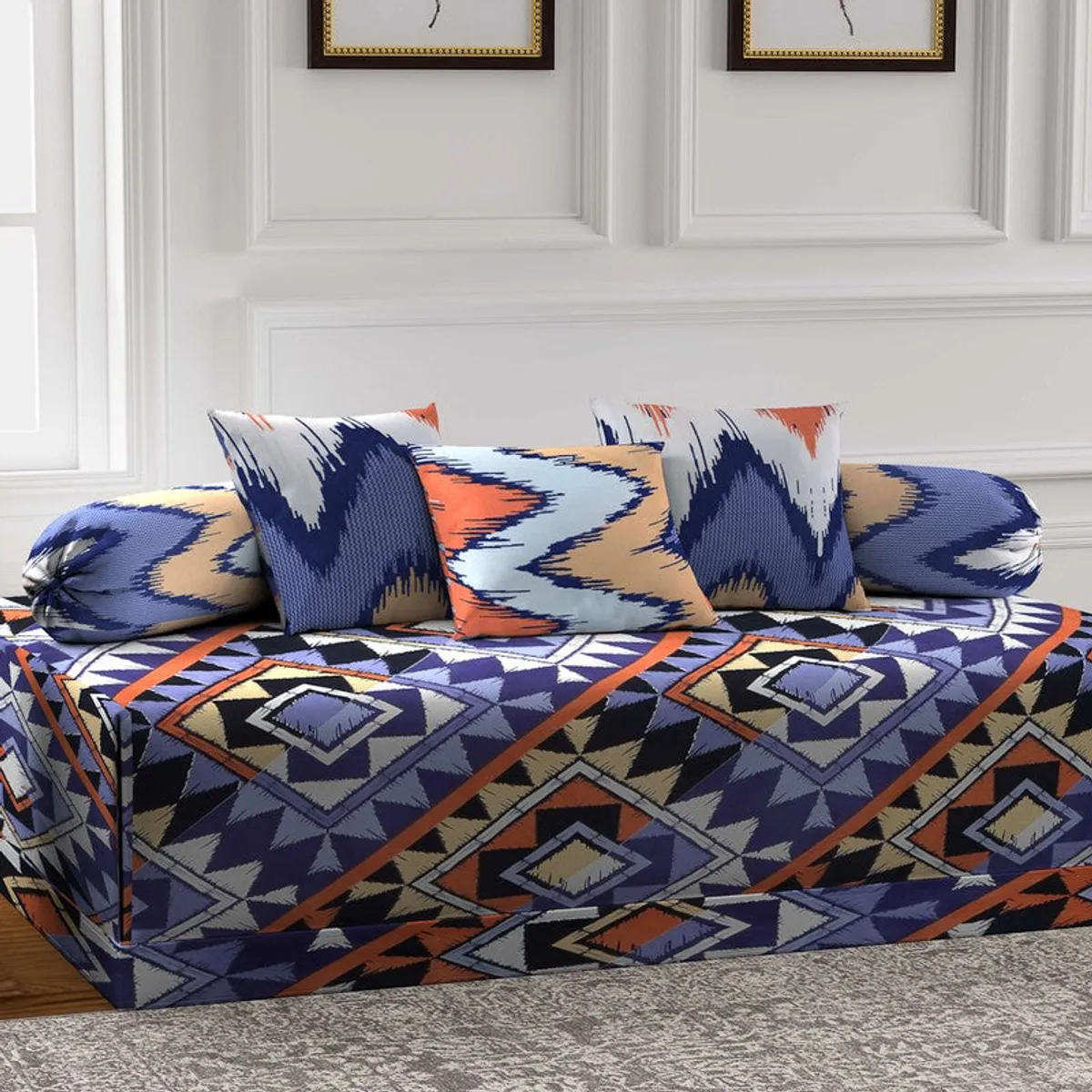 Angled view of multicolour geometric diwan set with two bolsters and three cushions