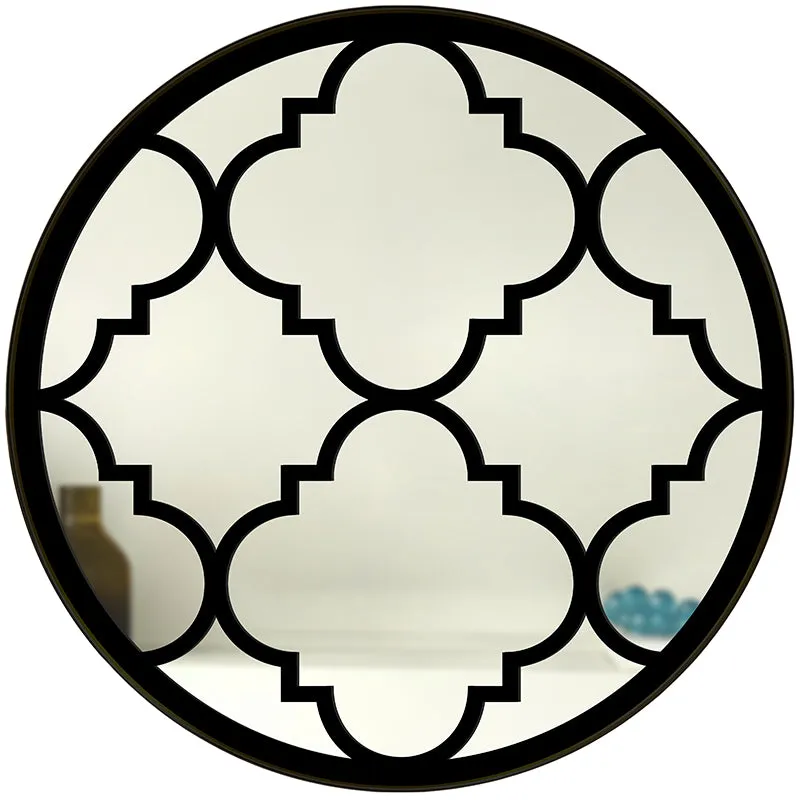 Front view of round decorative wall mirror with black geometric design