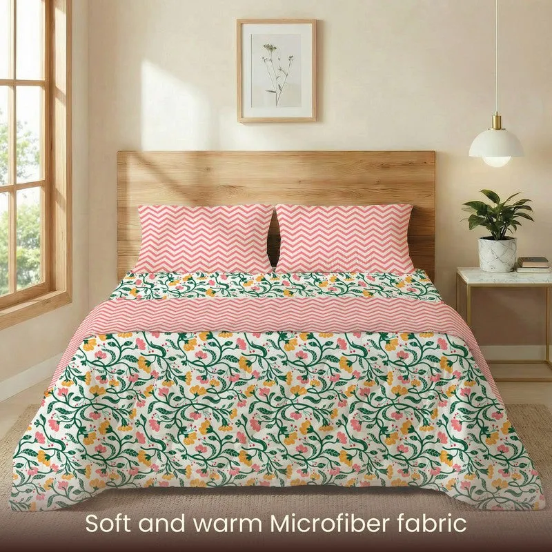 Front view of floral bedding set with pink patterned top layer and pillow covers