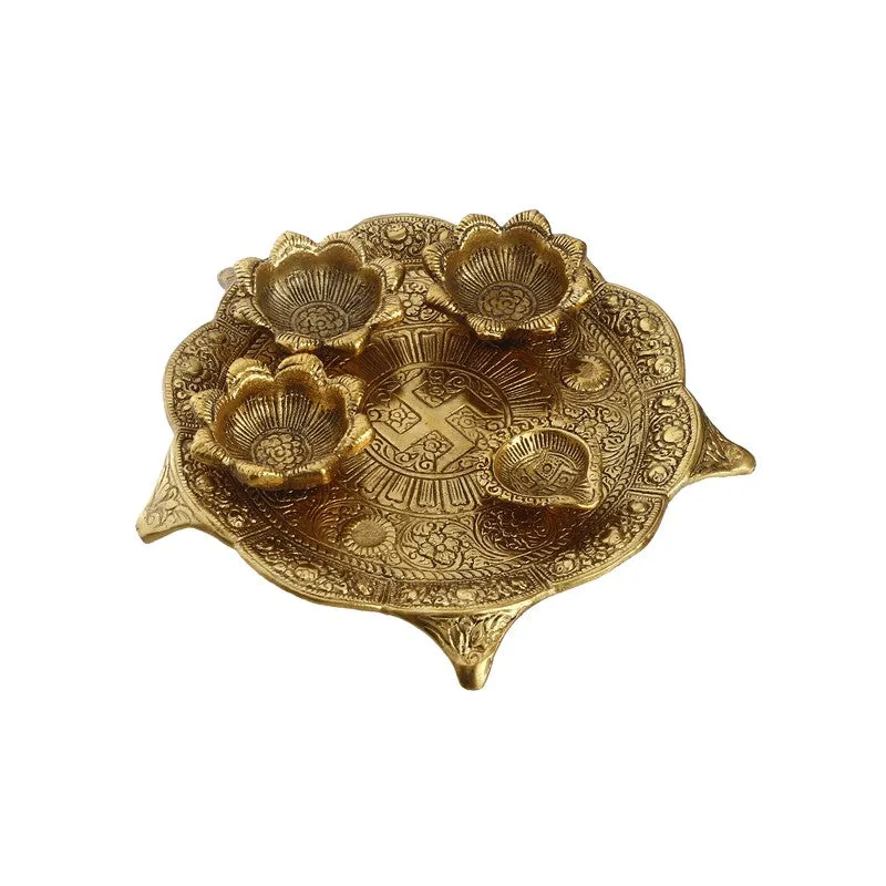 Top view of ornate gold pooja thali with floral bowls and embossed detailing