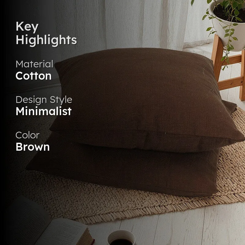 Brown cushion covers styled on a rug with material and colour highlights