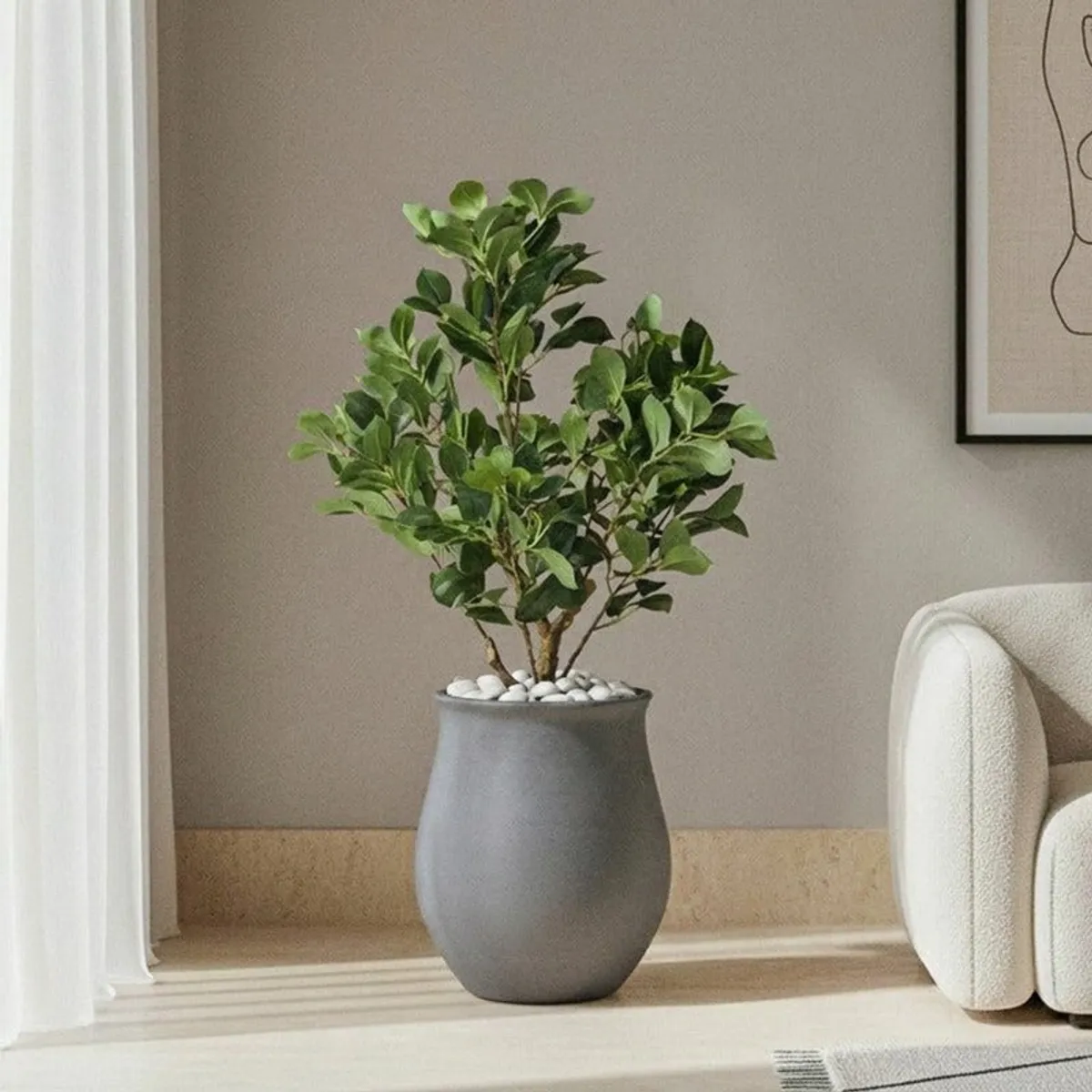 Grey floor planter holding a leafy plant in a contemporary living room