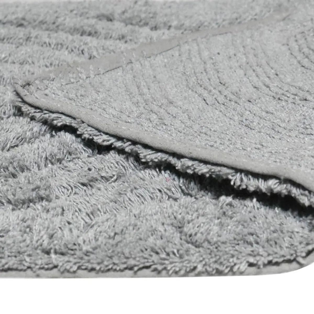 Folded grey bath mat showing the underside and pile texture