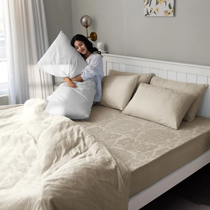 Person relaxing on a beige floral bedsheet with matching pillow covers