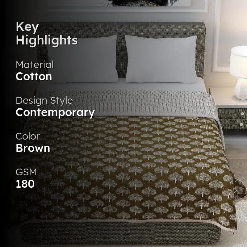 Brown tree-pattern dohar displayed on a bed in a bedroom