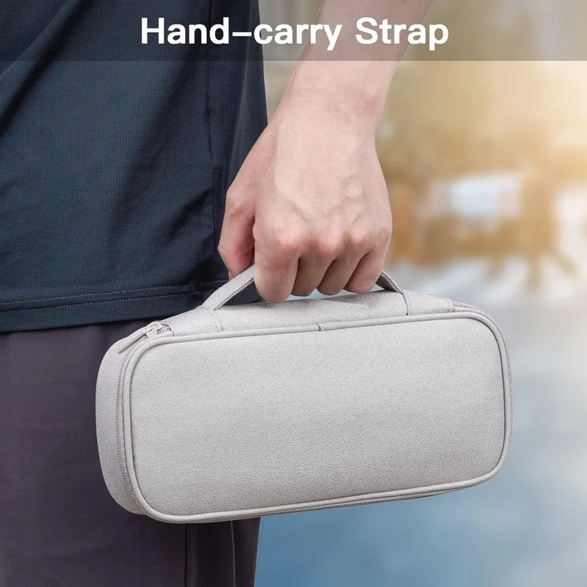 Grey storage bag being carried by its top handle.