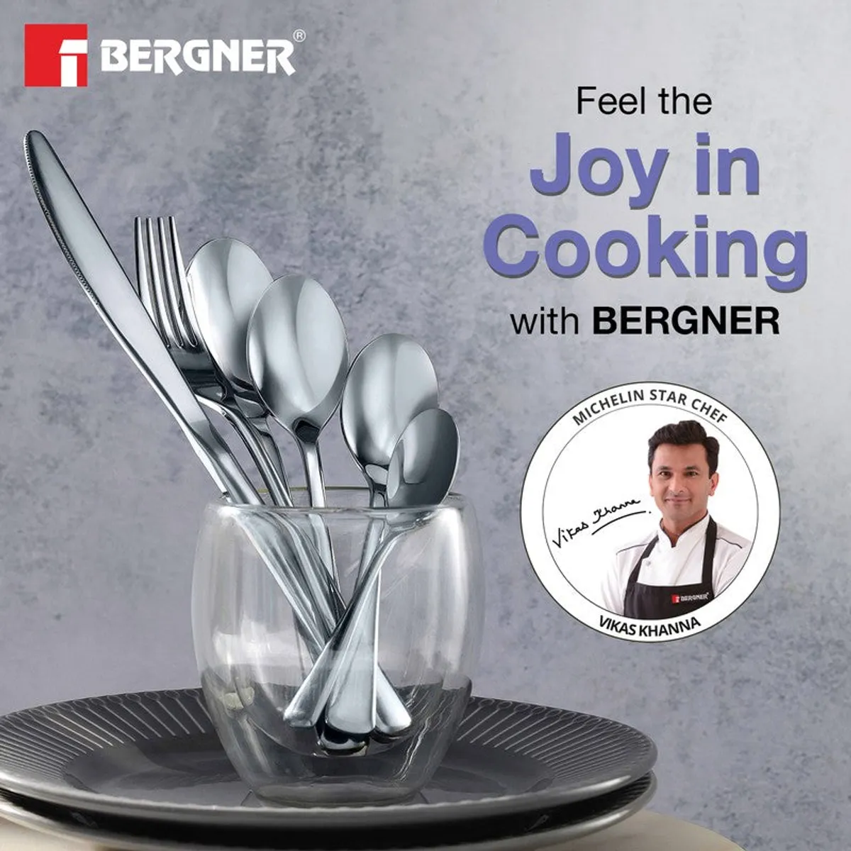 Silver cutlery displayed in a glass with a plate and Bergner branding