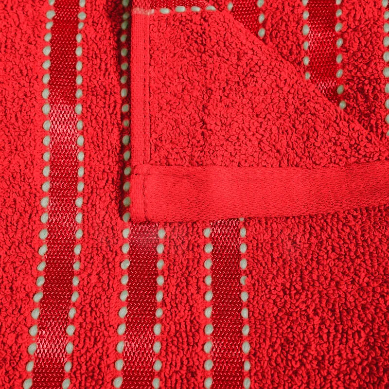 Close-up of the red towel's plush texture and striped border