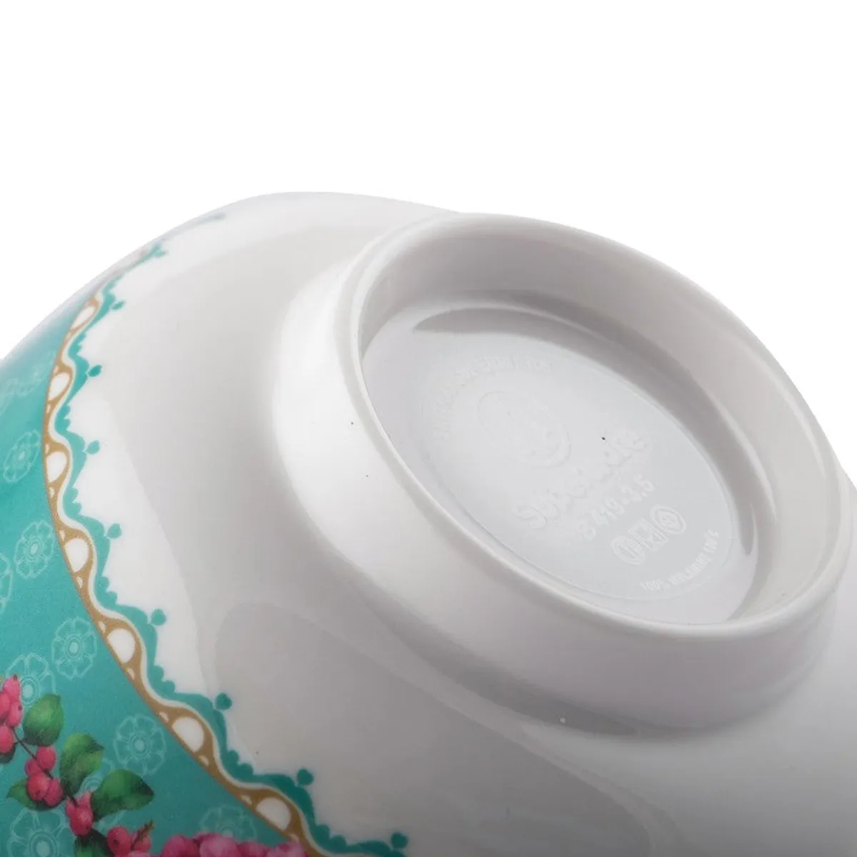Close-up of the white base and floral teal exterior of a snack bowl.