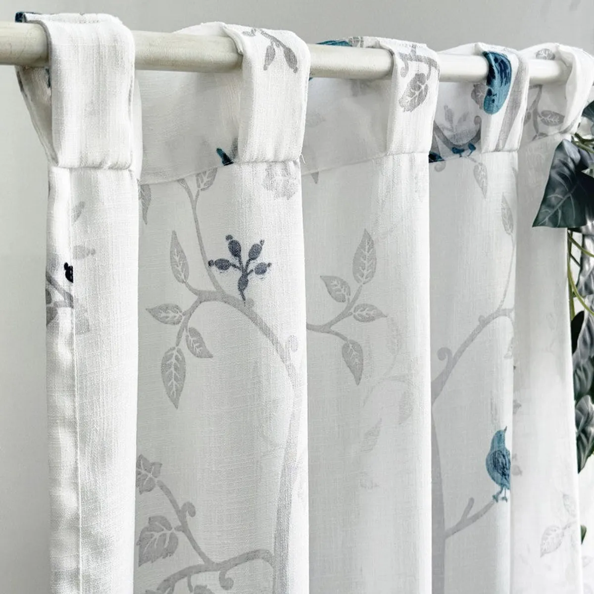 White curtain with back tabs, grey branches and blue bird pattern