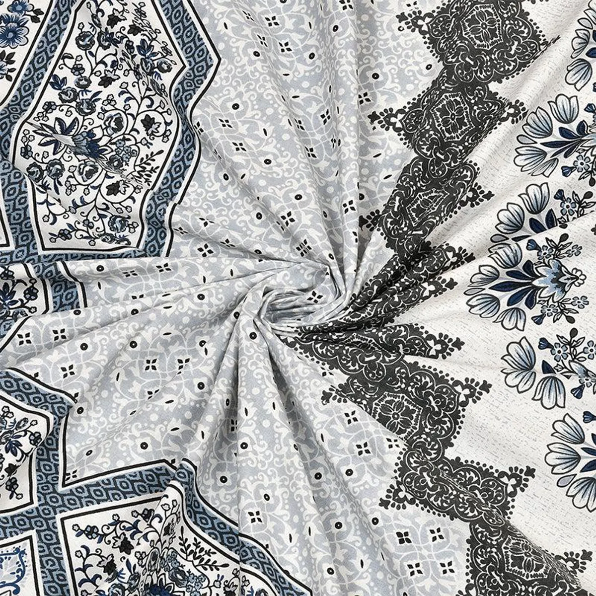 Close-up of grey, white and blue floral ethnic print on cotton bedsheet