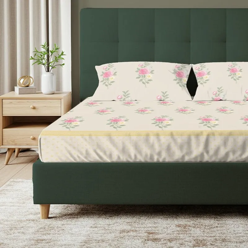 Front view of floral bedsheet with matching pillow covers on a green bed