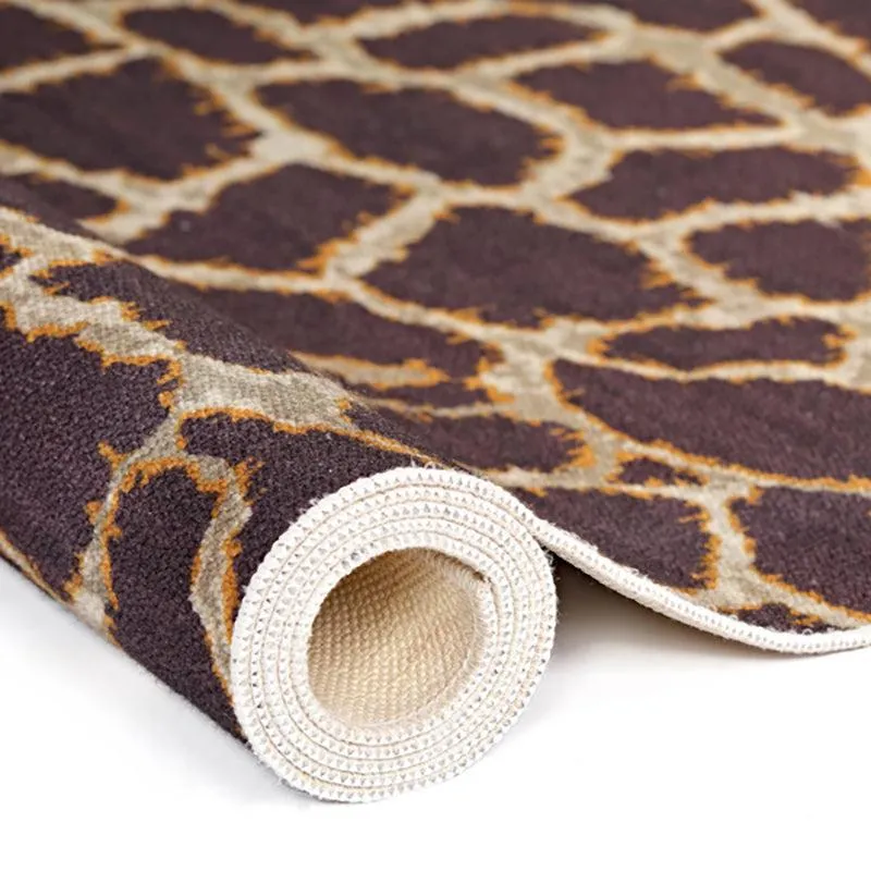 Rolled edge of the brown and beige carpet showing surface and backing
