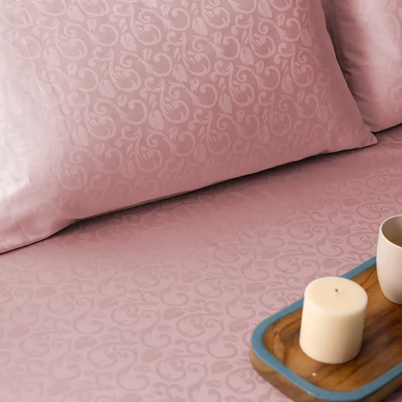 Close-up of the pink floral jacquard pattern on the duvet cover