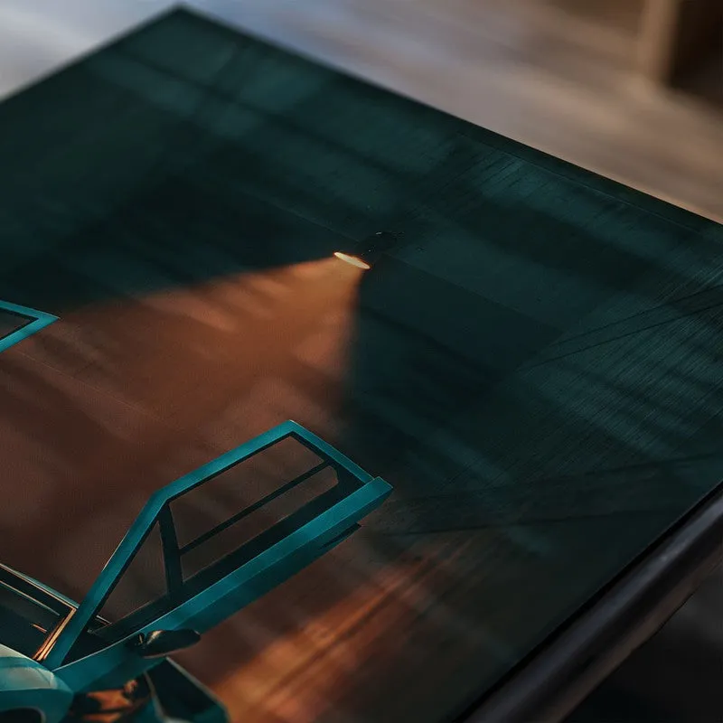 Close-up of a teal sports car poster with glossy surface