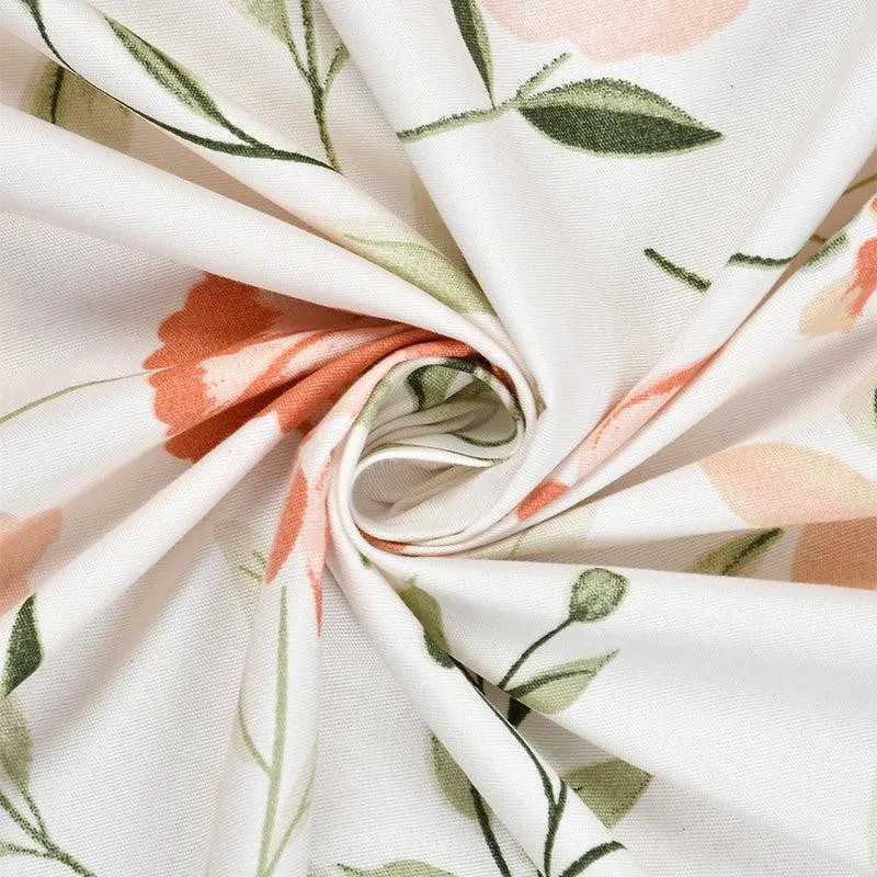 Close-up of white fabric with peach floral print and green stems