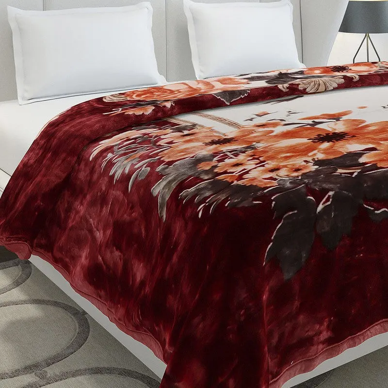 Close-up of the blanket's red velvet-look border and floral print