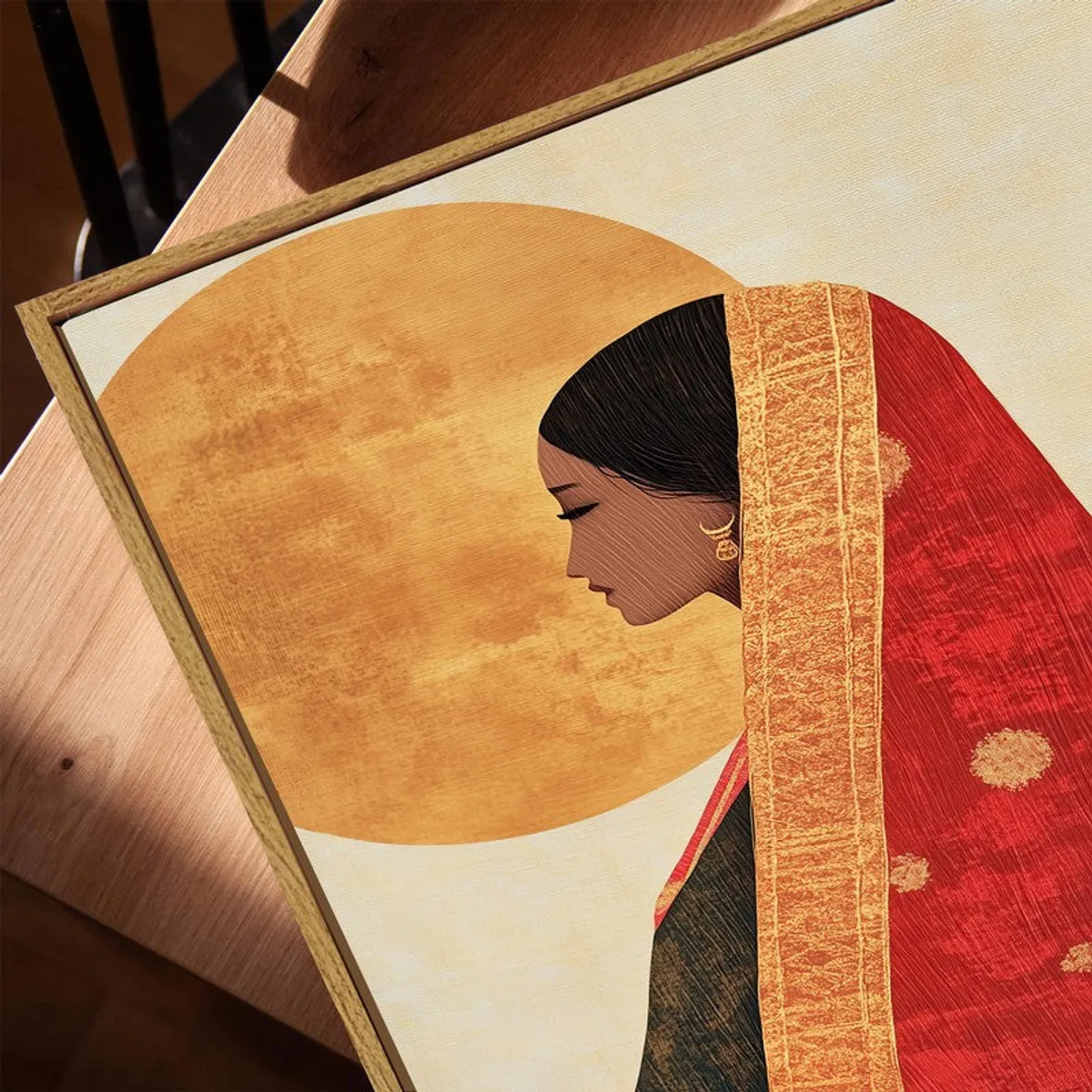 Close-up of the canvas texture and wooden frame around the saree artwork