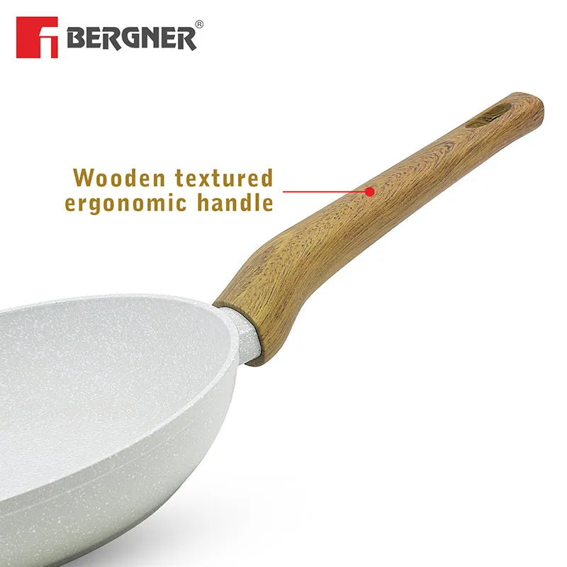 Close-up of the frying pan's single brown handle and speckled body