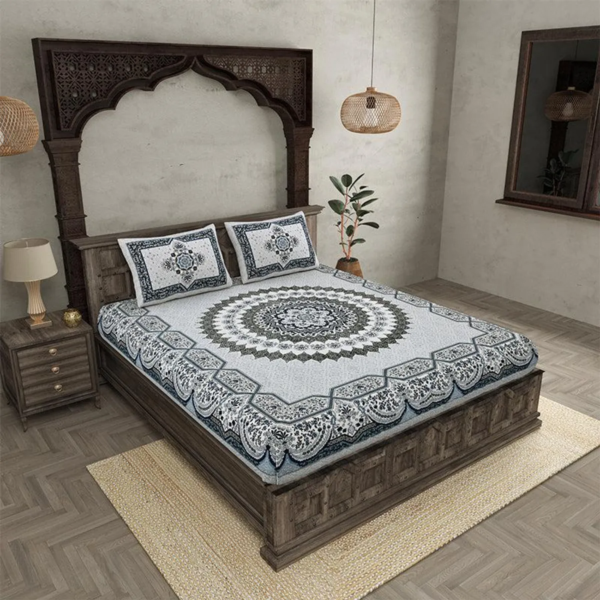 Flat grey bedsheet with ornate circular medallion pattern draped over a wooden bed