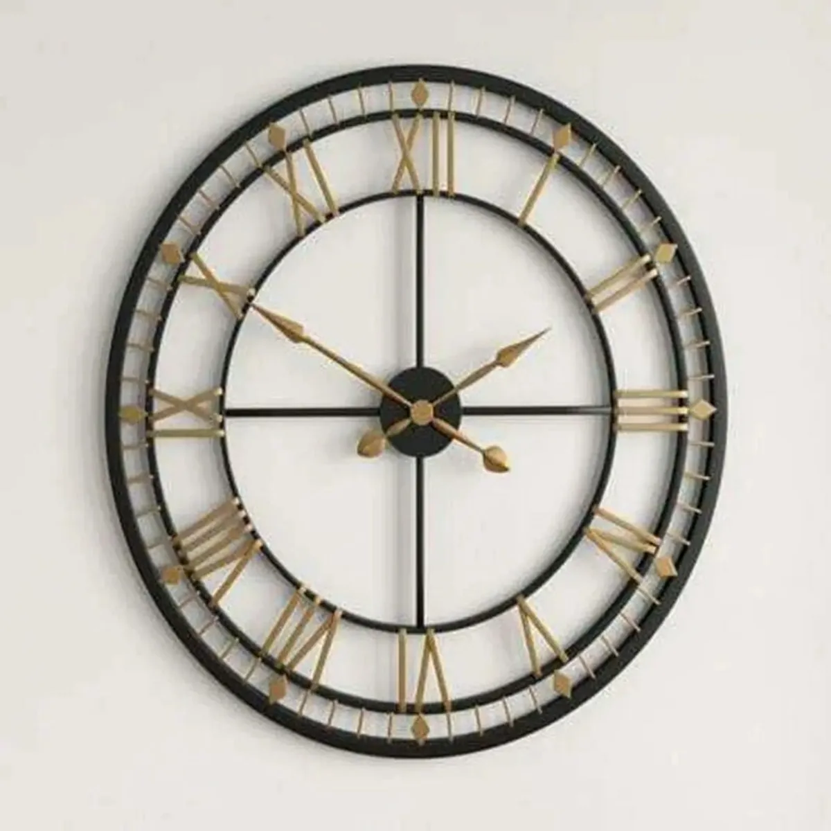 Front view of a round black and gold open-frame wall clock