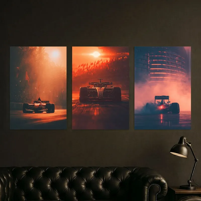 Set of three race car posters mounted above a dark sofa