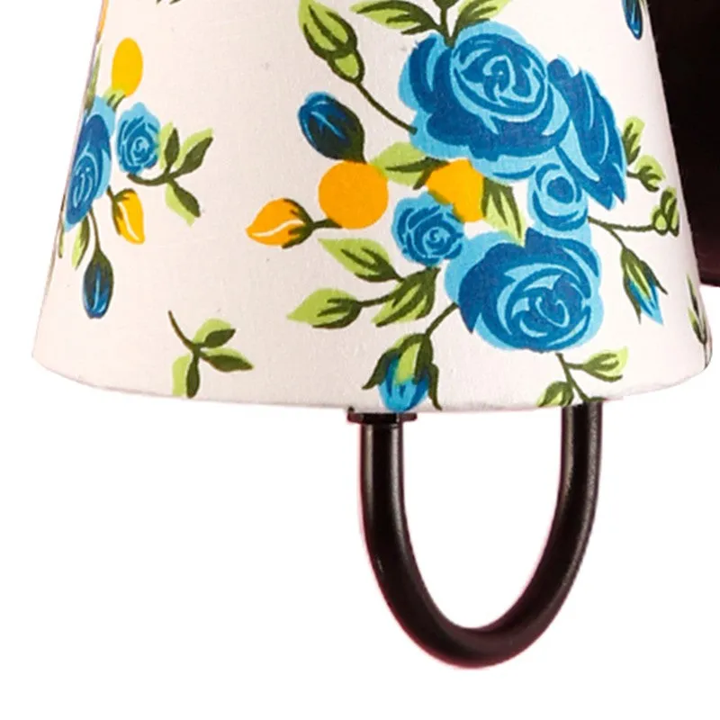 Close-up of blue floral print on white cotton lamp shade