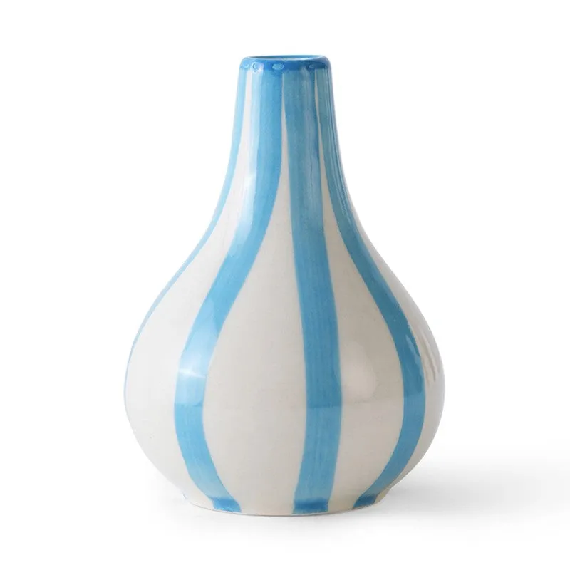 Front view of a white ceramic vase with blue stripes on a white background