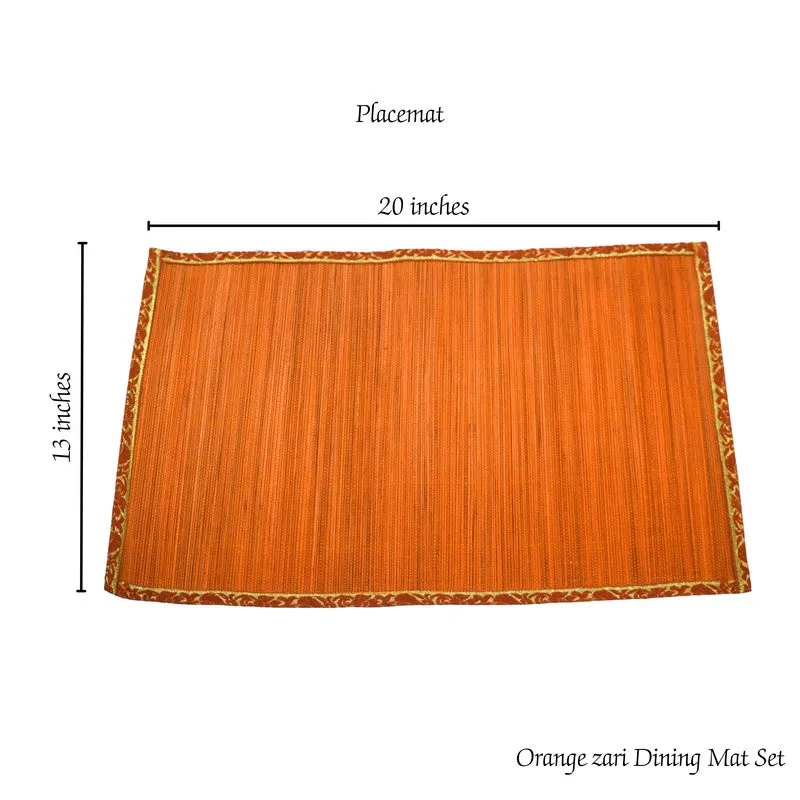 Orange table mat displayed with plates and cutlery on a dining table