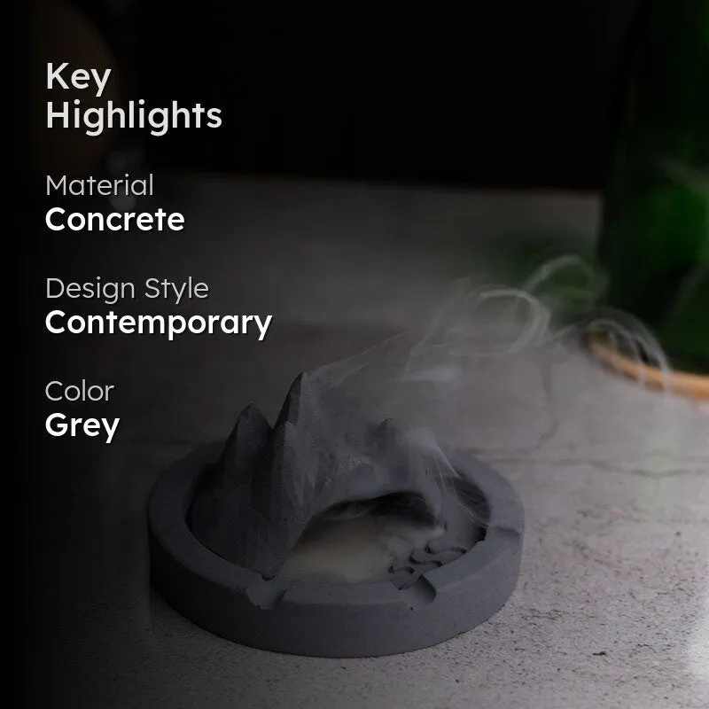 Grey concrete mountain-shaped ash tray styled on a tabletop