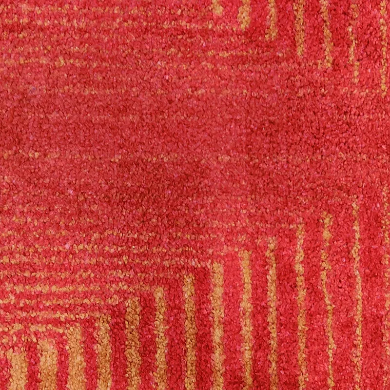 Close-up of the rug showing red pile with fine golden geometric lines