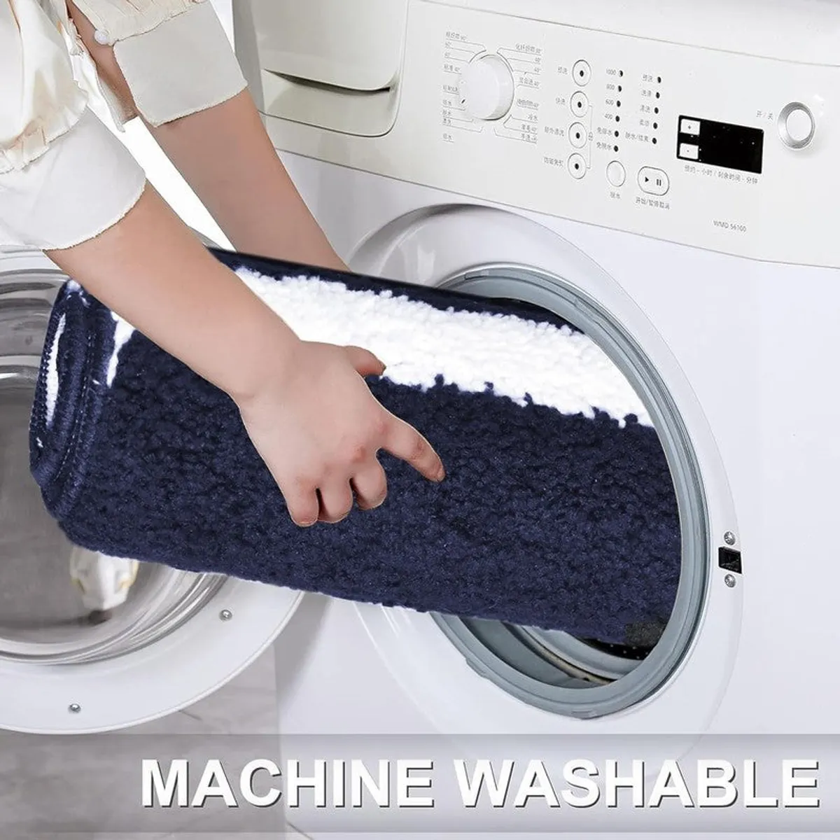 Rolled blue and white bath mat being placed into a washing machine
