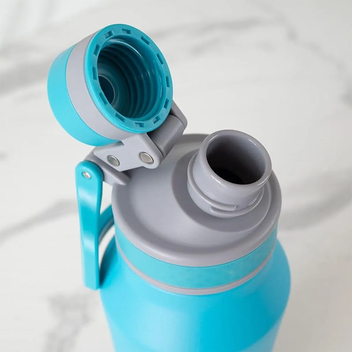 Open blue-and-grey bottle lid showing the threaded inner section