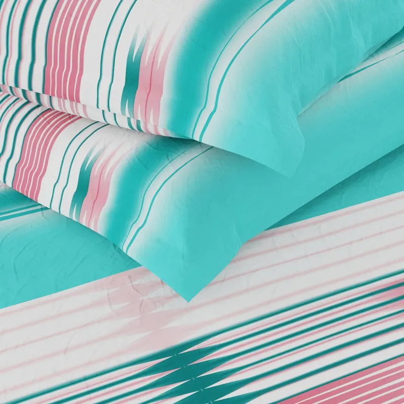 Close-up of soft sea green bedding with pink and teal striped details