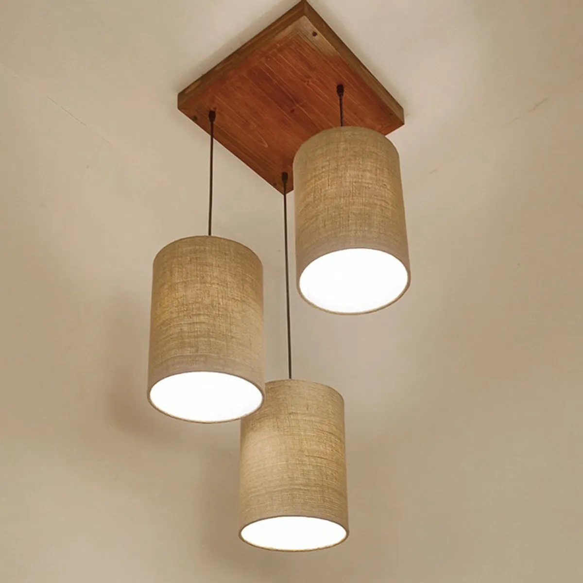 Close view of the lamp with three cylindrical beige shades