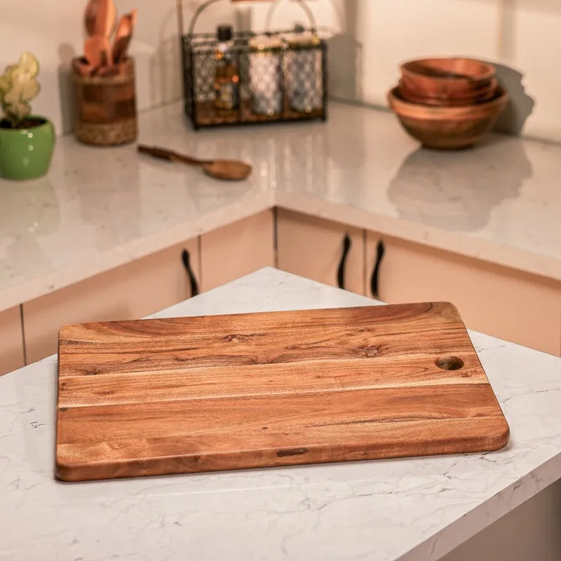 Natural wood chopping board shown on a kitchen island