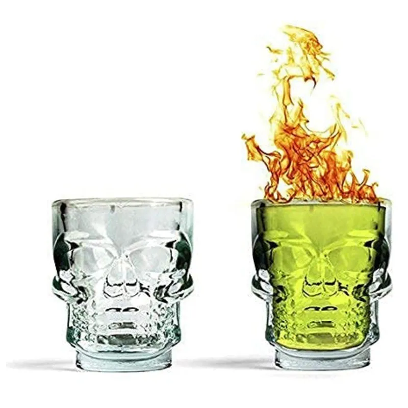 Clear skull shot glass shown with a green drink and a flame graphic