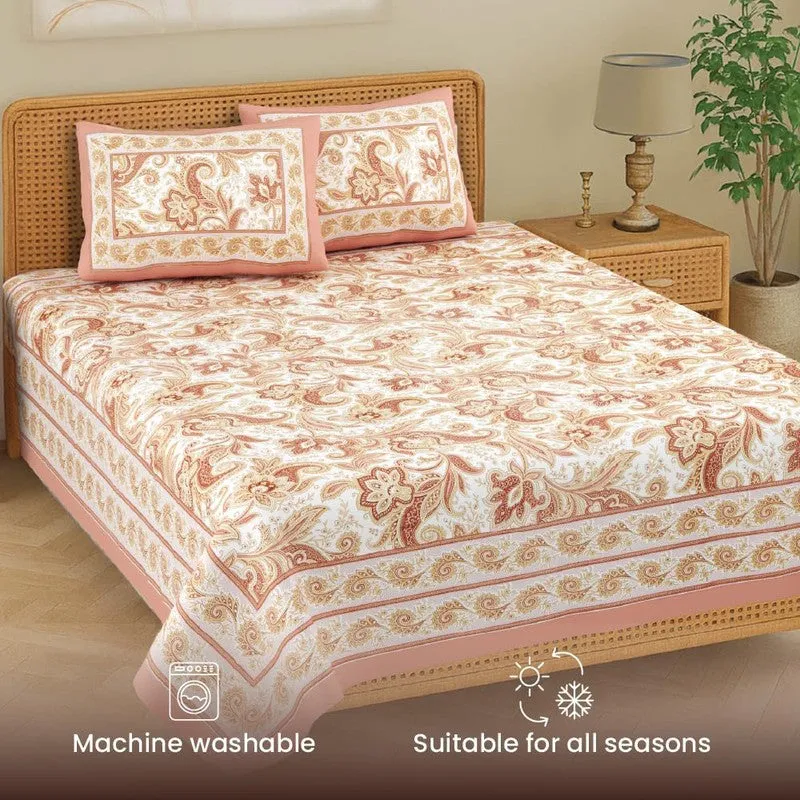Angled view of floral pink bedsheet with two matching pillow covers