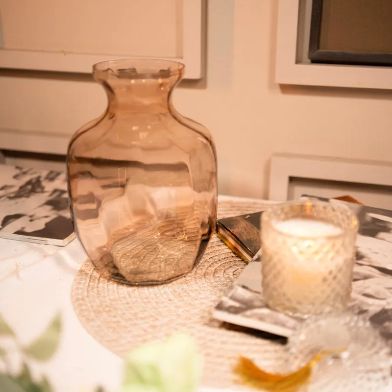 Empty peach glass vase on a tabletop
