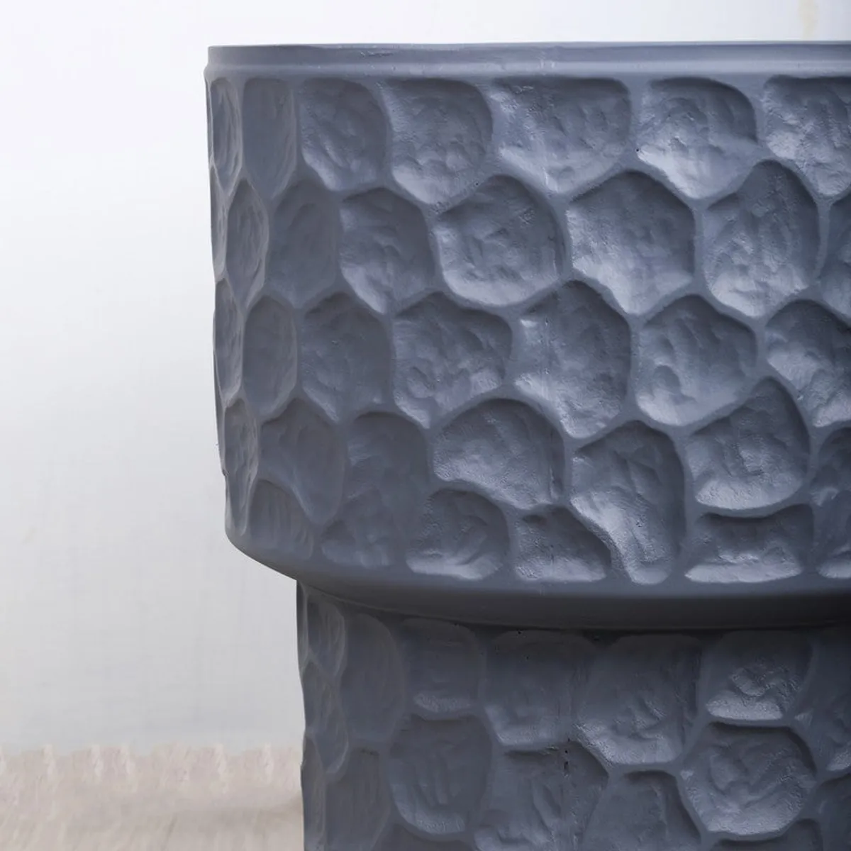 Close-up of the planter's raised grey textured surface