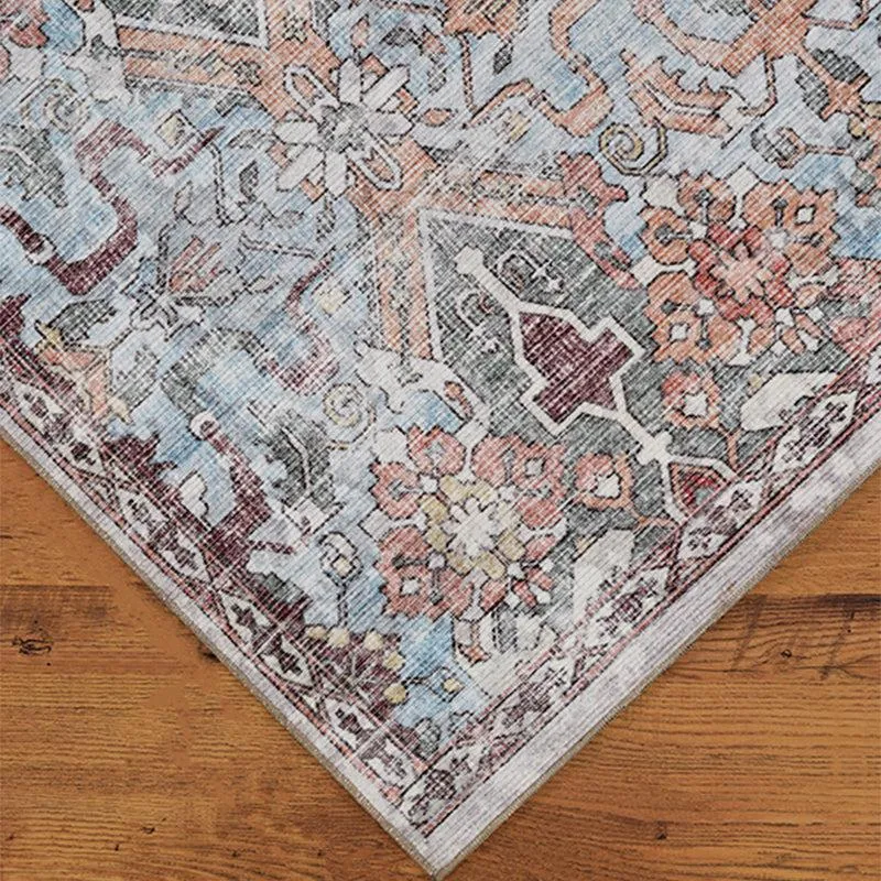 Corner view of patterned carpet in soft beige, grey and blue tones
