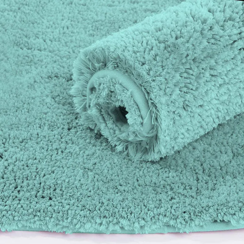 Rolled aqua microfiber runner rug showing its thick plush pile