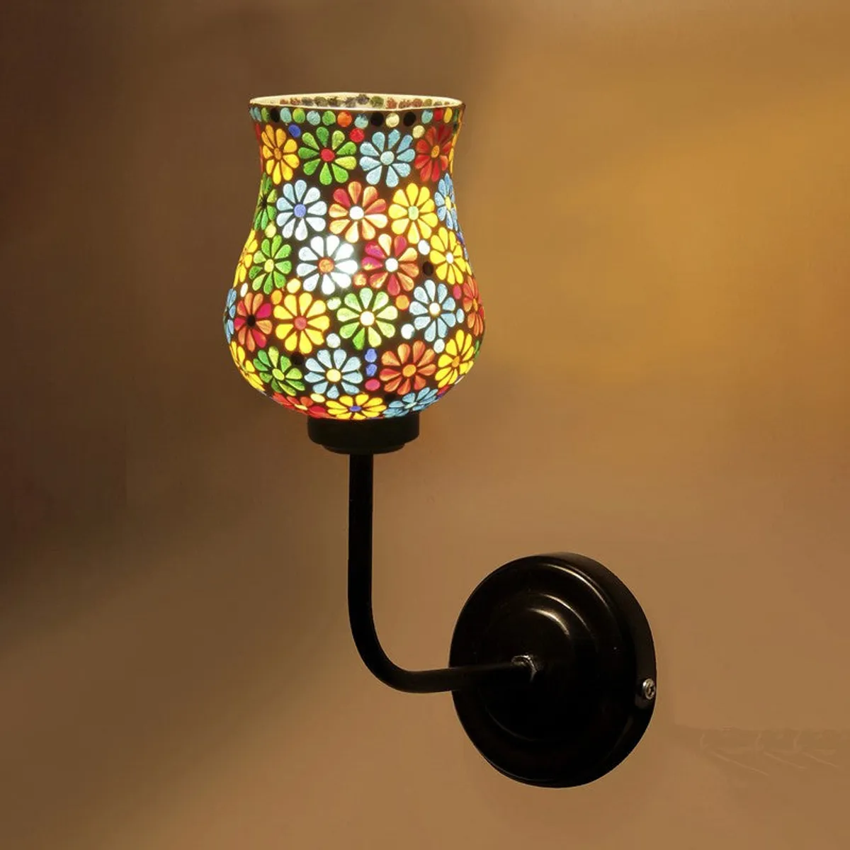 Close view of lit floral mosaic glass wall lamp