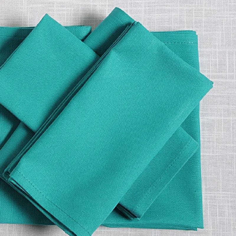 Close-up of folded teal blue cotton napkins