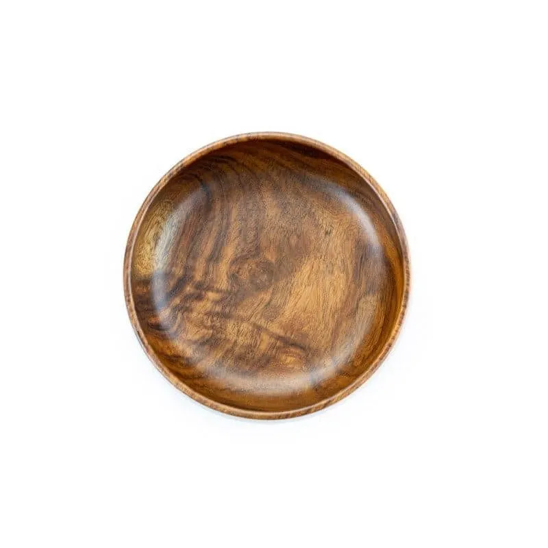 Top view of a round brown wooden bowl with natural grain