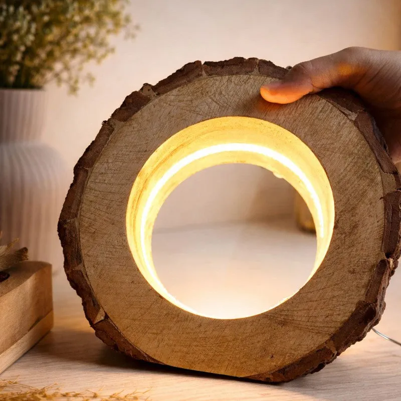 Front view of a rustic round wooden lamp with warm inner glow