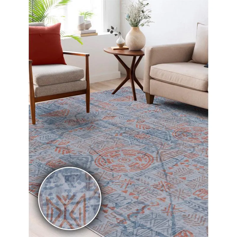 Blue and red patterned carpet placed between living room seating