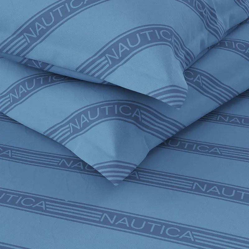 Close-up of blue cotton fabric with darker diagonal Nautica stripes