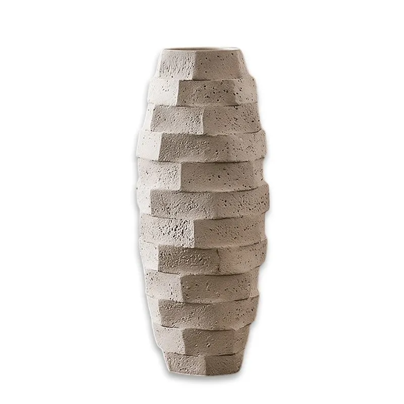 Front view of a textured white geometric vase on a white background